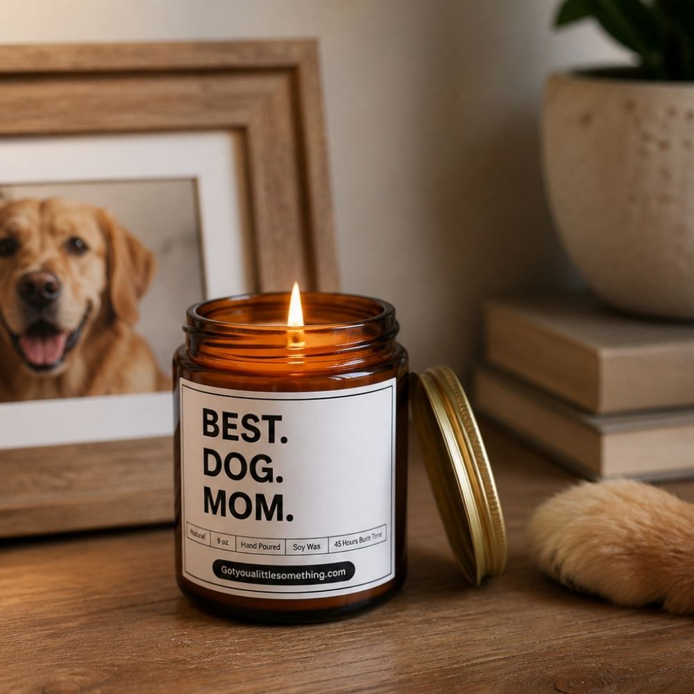 Best Dog Mom soy wax candle on a wooden surface beside a framed golden retriever photo, a heartfelt gift for dog moms